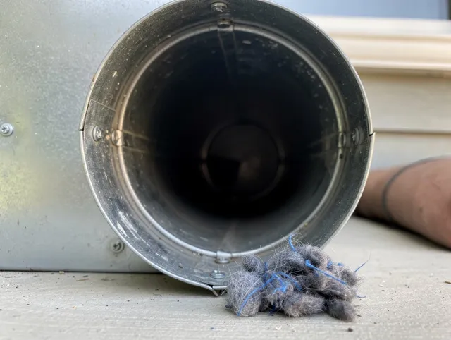 Lake Elsinore Dryer Vent Cleaning technician using specialized equipment to clear severe dryer vent blockage in Lake Elsinore